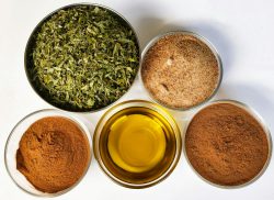 Four bowls filled with different types of spices